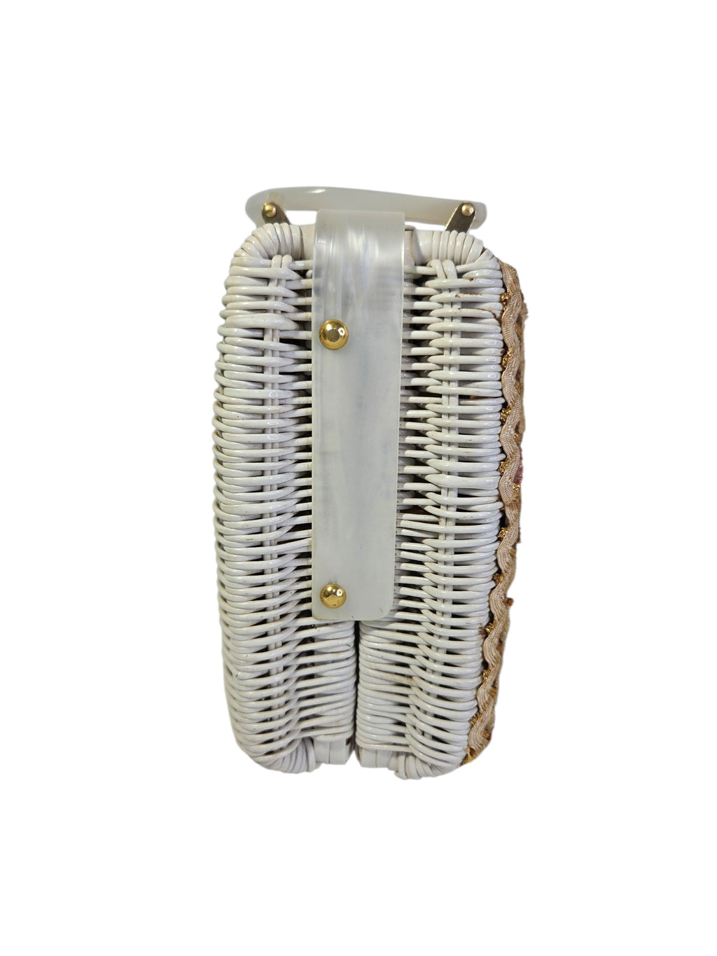 End of the white painted wicker purse with a pearlized Lucite strap held by two gold-tone studs