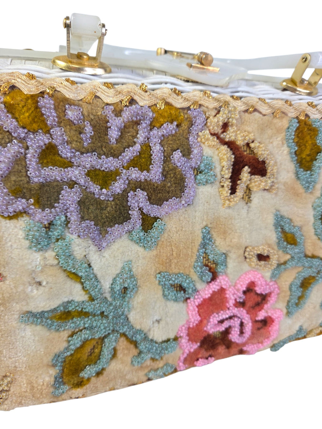 Close-up of the glass seed bead outlines on the plush velvet flowers, with gold ric-rac trim along the top edge