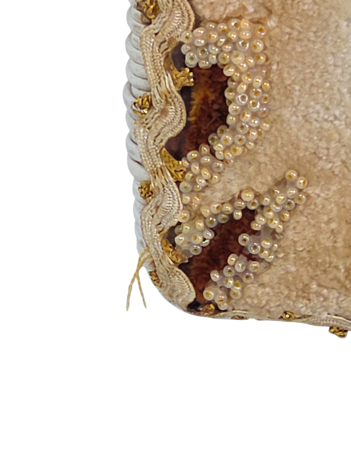 Close-up of the cream iridescent seed beads outlining a brown velvet leaf