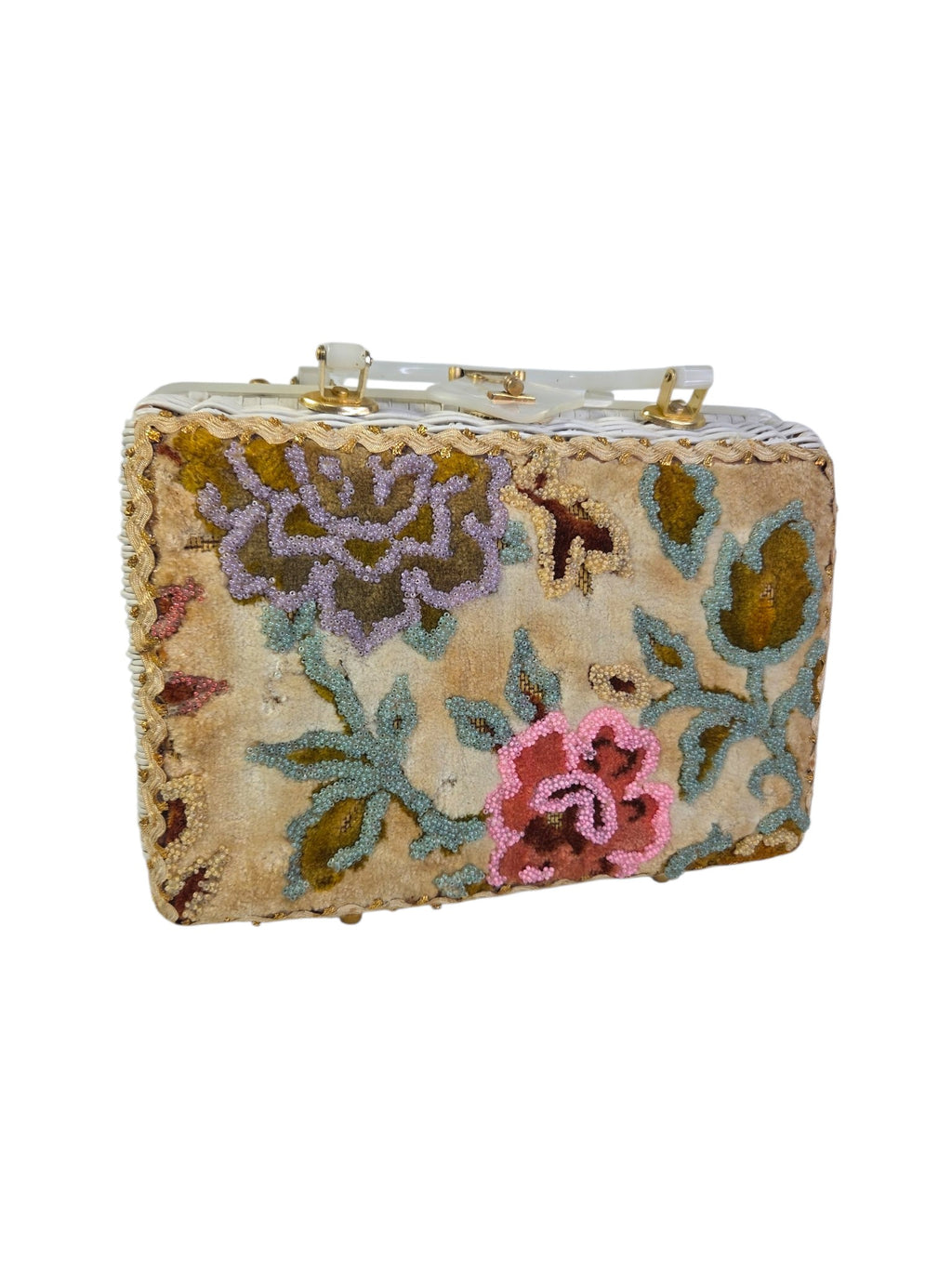 Angled view of the beaded velvet floral panel with lavender flower, pink rose and blue-green vines on the wicker box purse