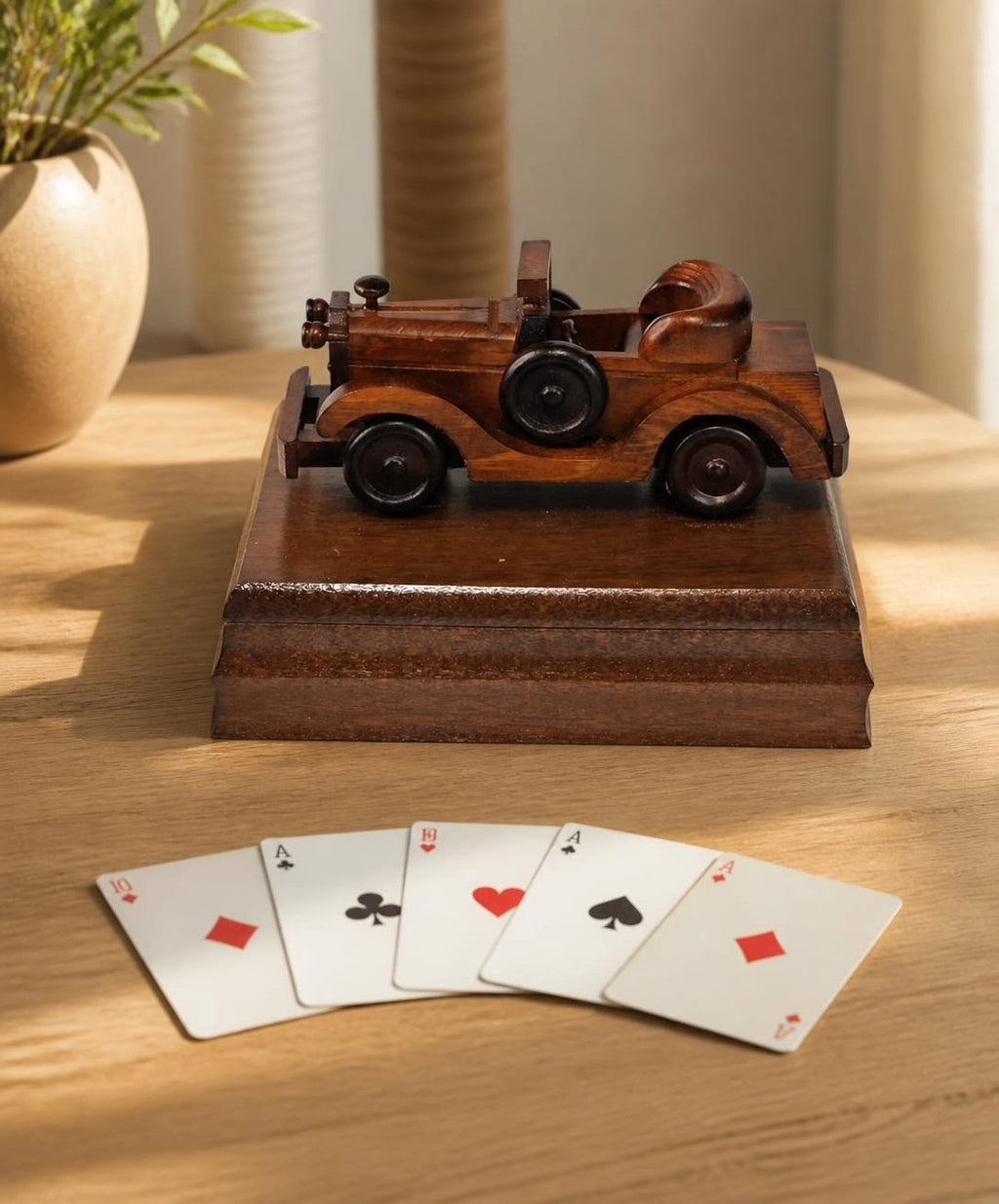 Oddly Darling Vintage wooden playing card storage box featuring a carved antique car lid on a wooden table with cards