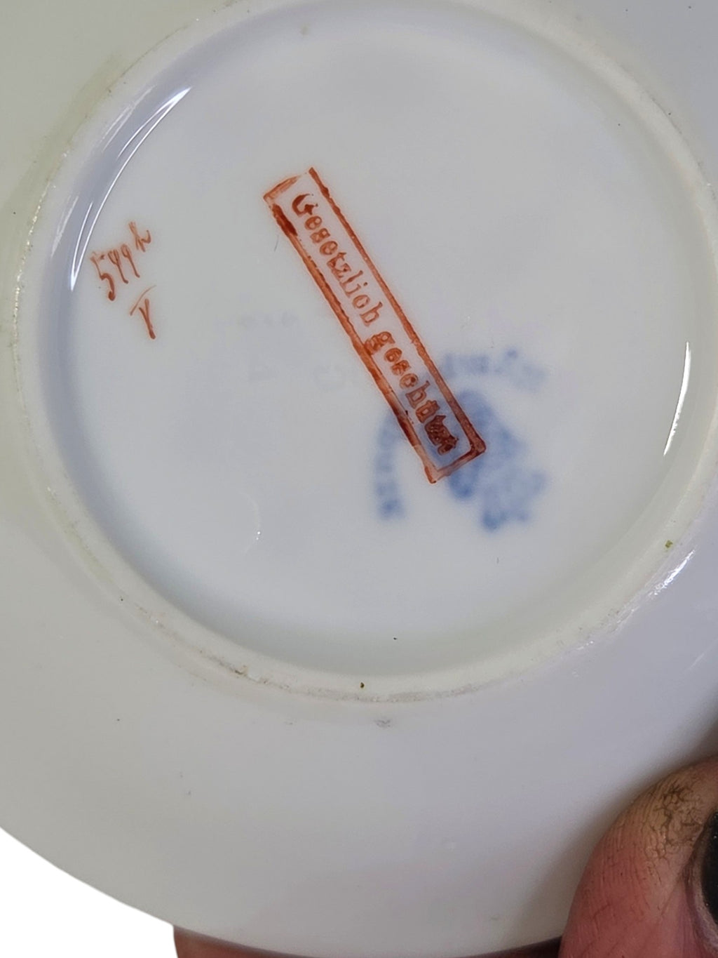 Back of the dish with red Gesetzlich Geschutzt stamp, hand-painted red pattern number and faint blue factory mark