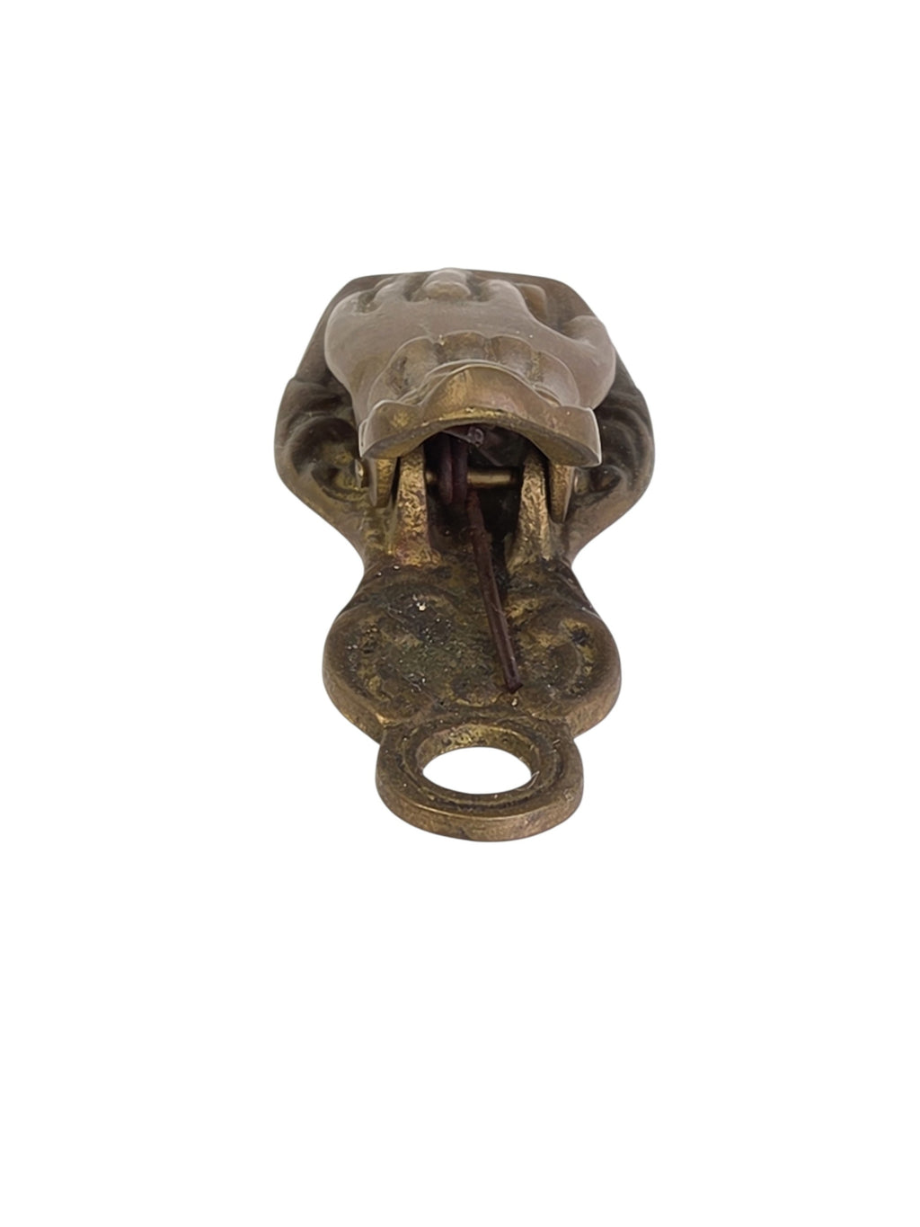 Side view of the brass hand clip lying flat, showing its low profile and dark patina