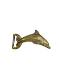 Vintage solid brass leaping dolphin belt buckle on white, tail curled into the belt loop